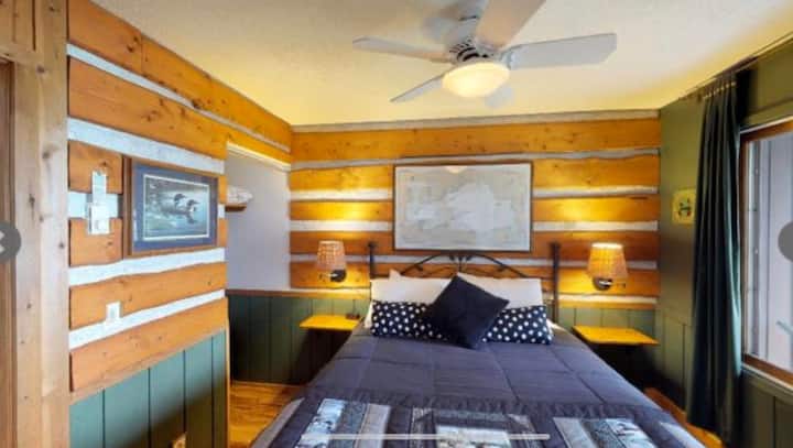 Master bedroom with log cabin feel.  