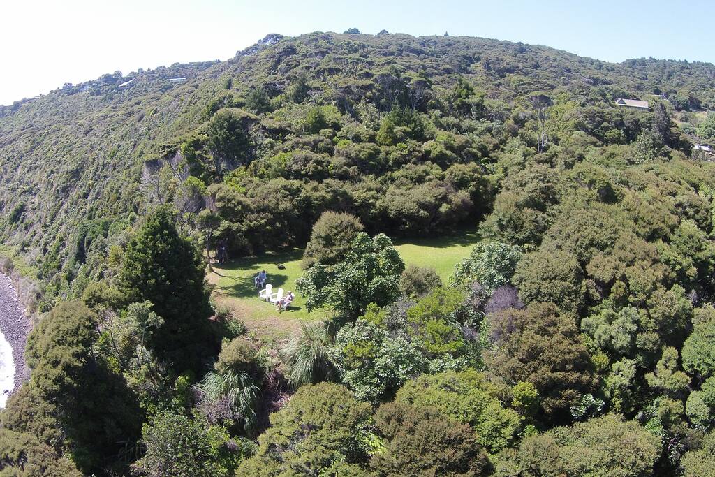 Ocean lookout and lawn with cottage seen in top right. (aerial shot)