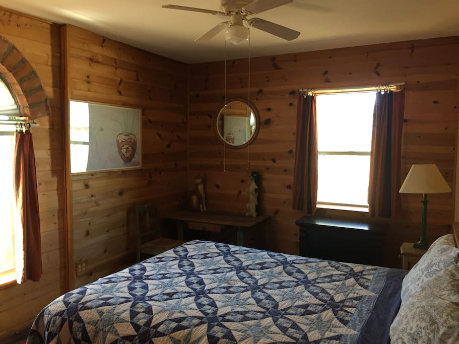 Guest bedroom with Queen bed, south and west facing windows.