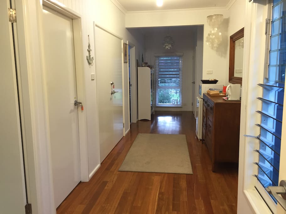 The foyer and kitchenette. Note : there is no stove top, oven , sink.
The is a microwave oven, mini fridge, jug and Nespresso coffee machine.