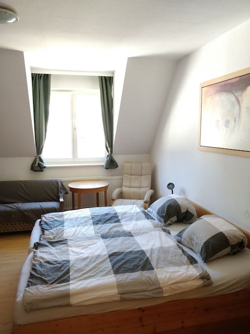 Queen bed in brightly-lit room