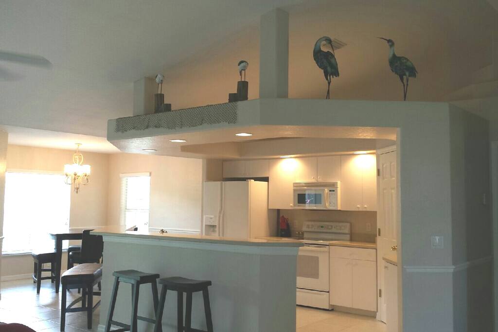 Open concept kitchen. Bar stools and counter gives you plenty of eating area. You can also see the dining room.