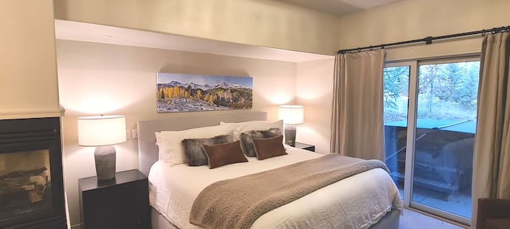 Downstairs Primary Bedroom with adjustable King size Bed and cozy fireplace.  This room walks out to the Hot Tub.