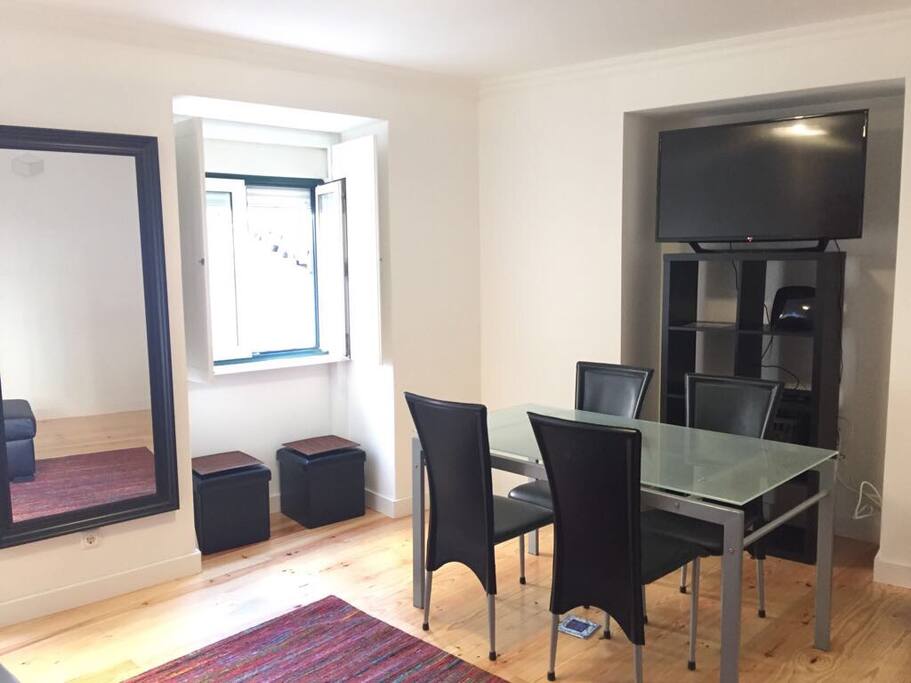 Living room with sofa bed, tv and dining table