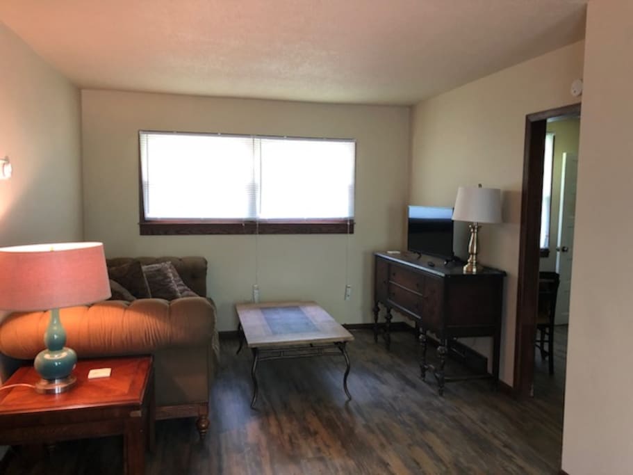 Spacious living room with Ethan Allen couch and smart TV