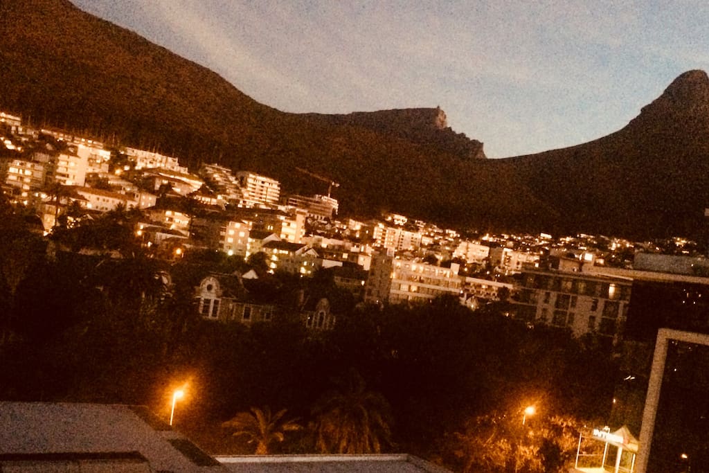 Sunset gives a special light to the homes under Signal Hill , Lion Head & Table Mountain