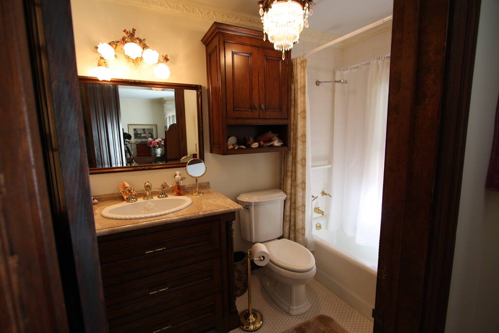Complete full bath with shower, tub and granite counter top sink.