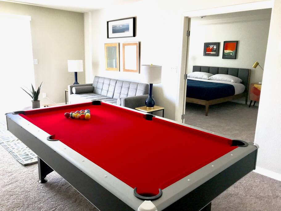 First Floor: Living Room 1 w/ Pool Table, Sleeper Couch and TV that leads to Master Bedroom 1