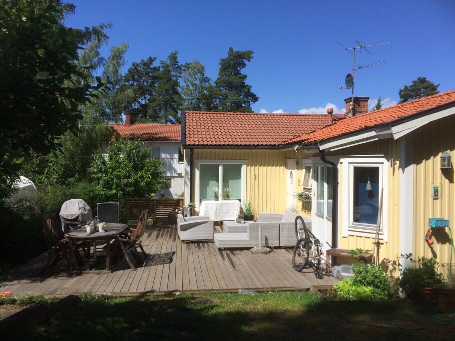Stor altan med longesoffa och matbord med plats för 8-10 pers.