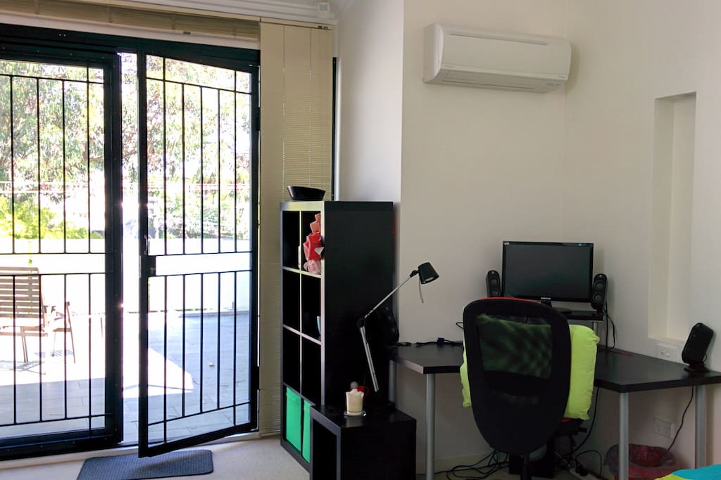 Desk, air conditioning, storage and full fly screen & glass doors to sunny balcony
