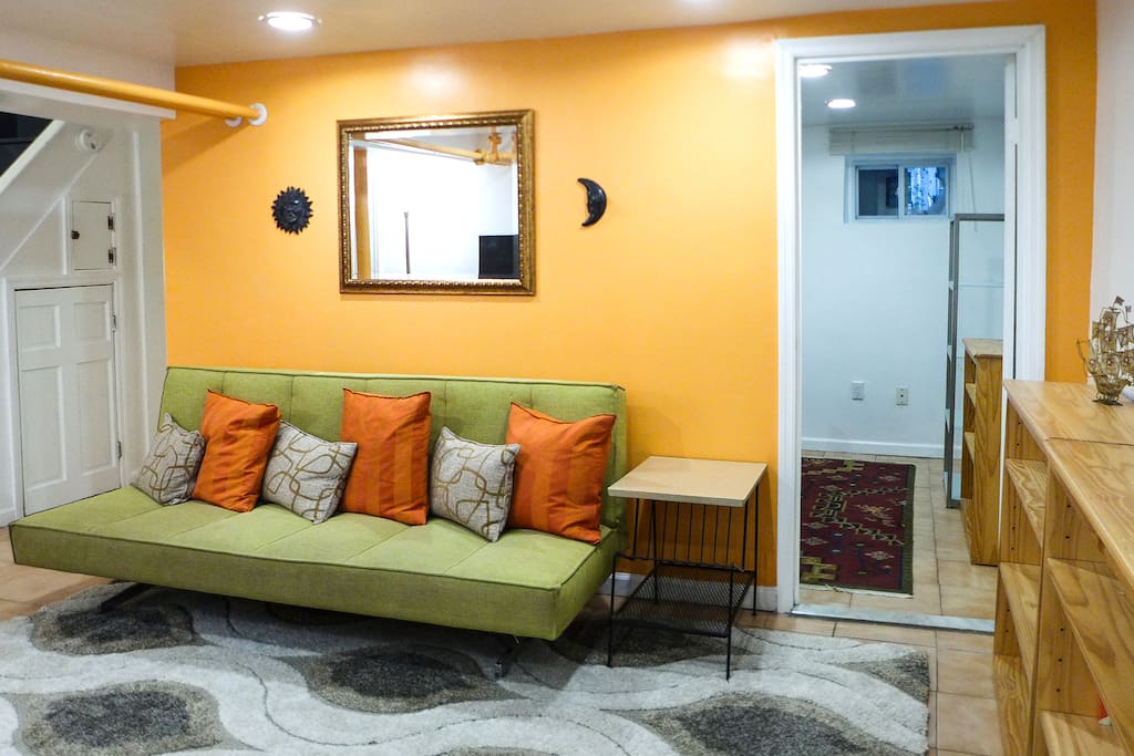 The CB2 sofa folds out into a queen-sized bed (sleeps two). Through the door is the bedroom with a window, closet, and queen bed.