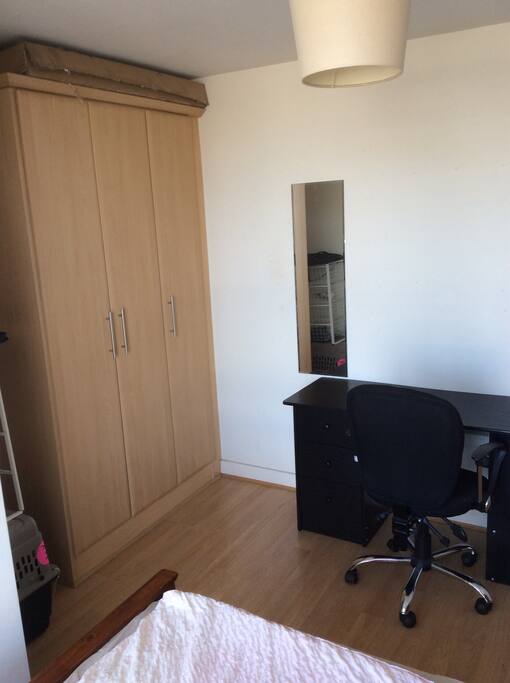 Wardrobe space available to hang up items as well as a desk.