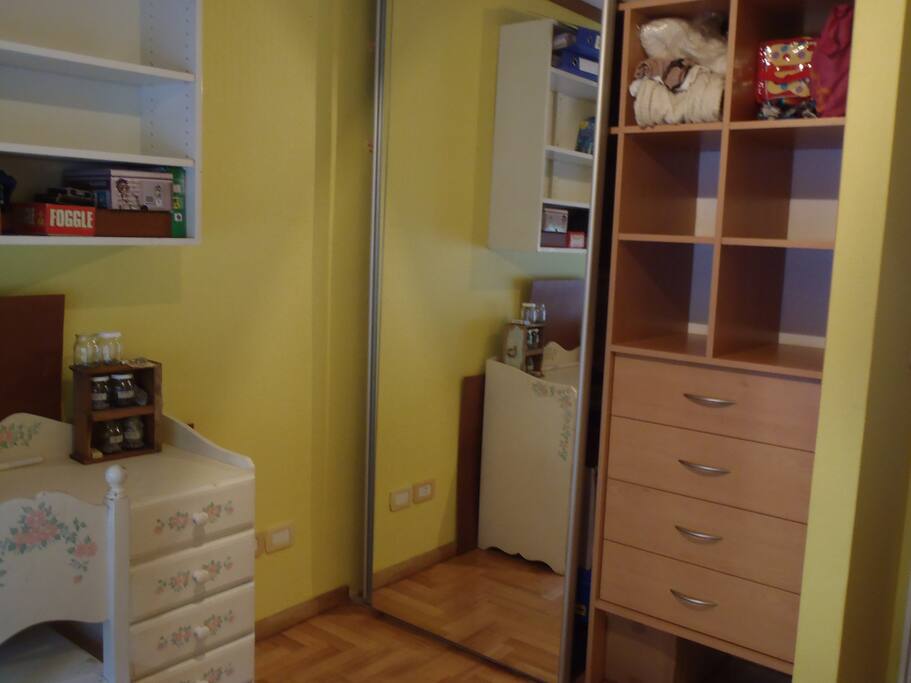 Personal desk and huge mirrors. Waredraws, shelves and hangers on the other side.