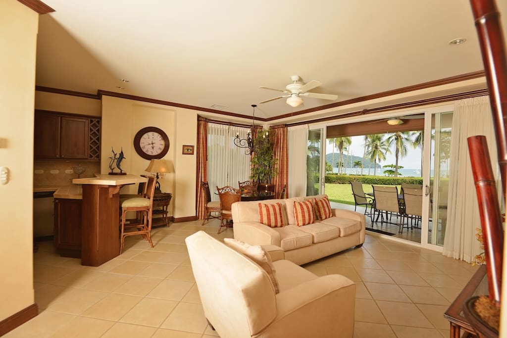 Open living room space, with ocean view and large graden.
