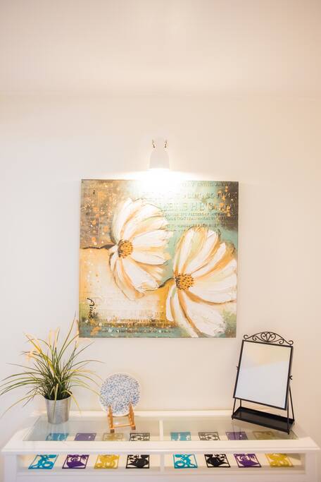 Picture and side table in corridor leading to bedrooms