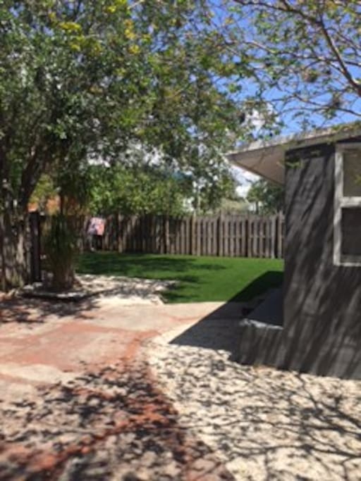 Secure court yard area with artificial turf area.