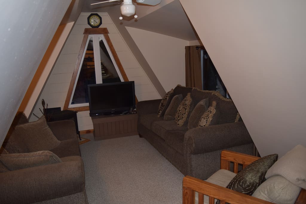 Living room with plenty of seating, and cable TV