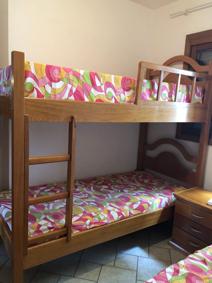 Bedroom with 3 beds and an extra mattress