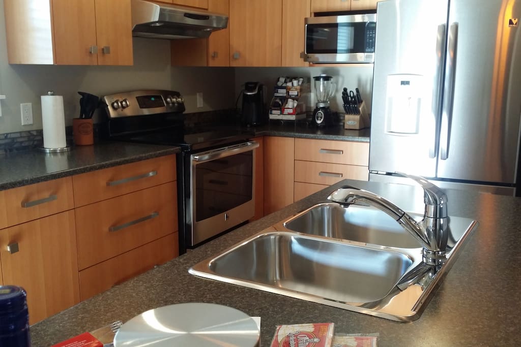 Full sized - amply stocked kitchen.
