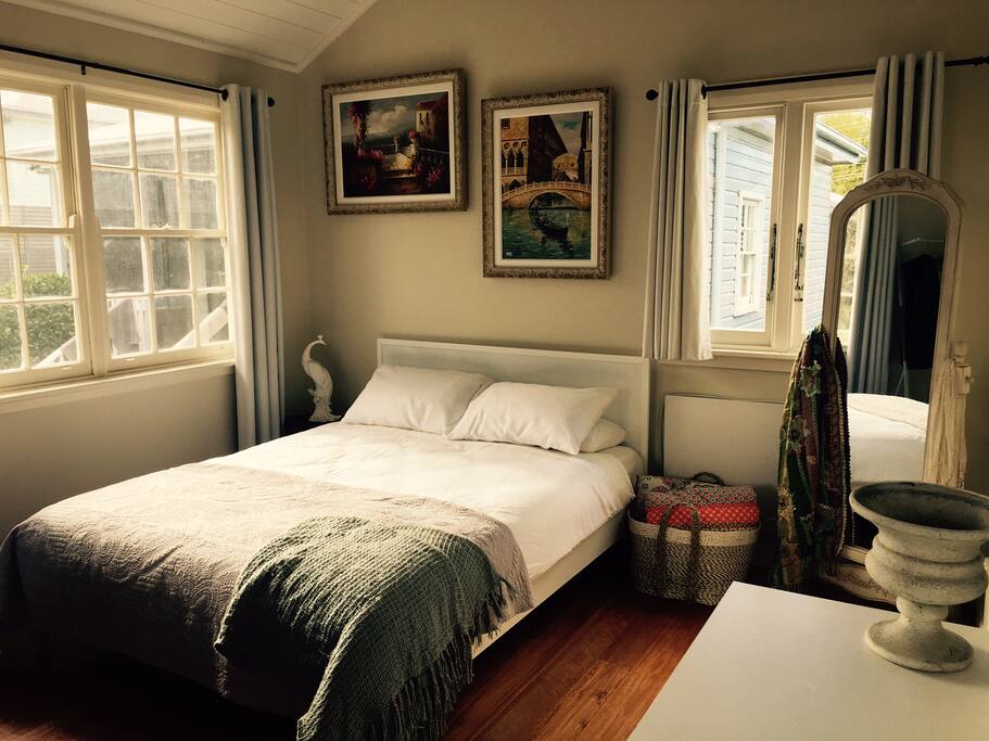 A beautiful queen bed with luxury European sheets. And a computer desk do pop your laptop on.