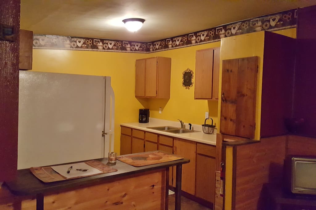 new ceiling & wallpaper border, stove, fridge, cookware, dinnerware for 4 people, coffee pot, microwave