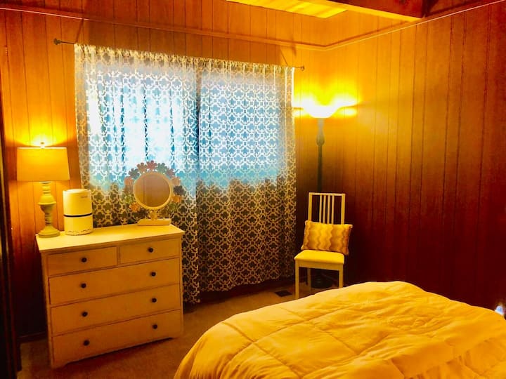 Downstairs private room includes a full bed, dresser, and large picture window,