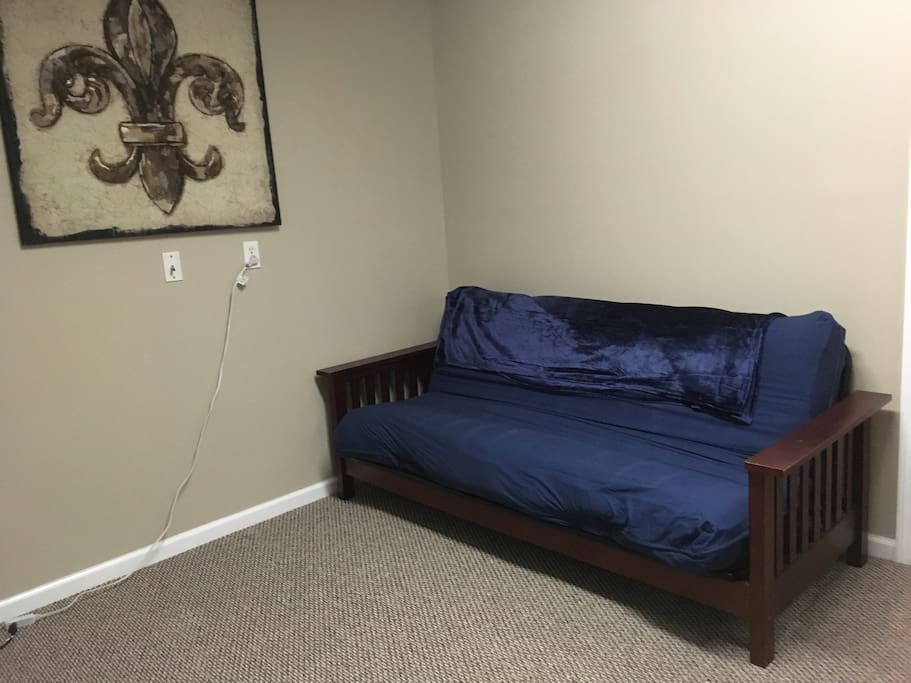 As you enter from the outside to the left. Futon pulls out to a double bed...insanely comfortable mattress!