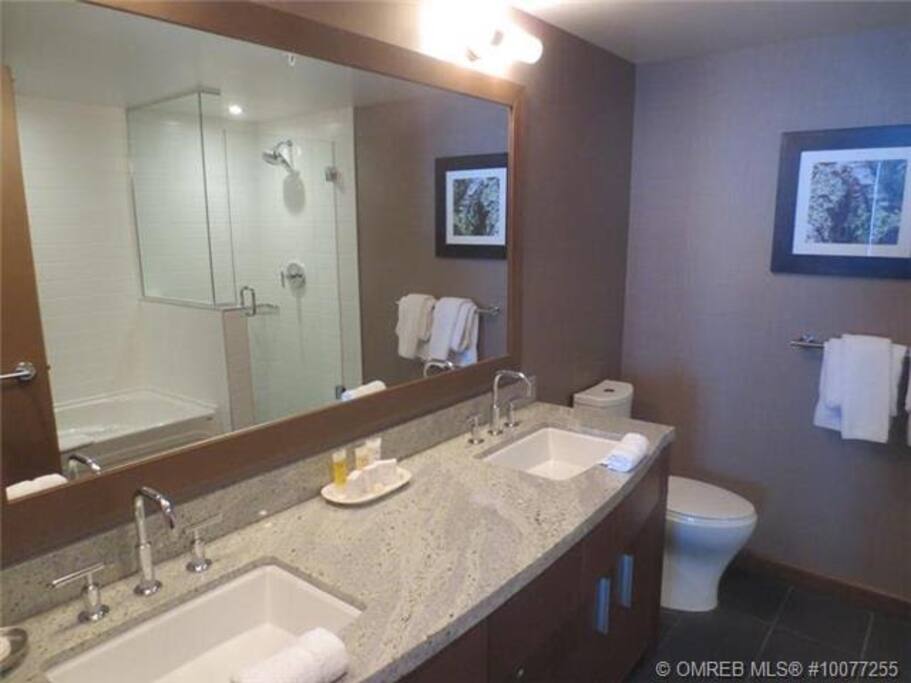 One of the two bathrooms, each with double vanities and showers.