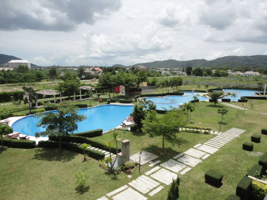 Huge pool w/ green areas