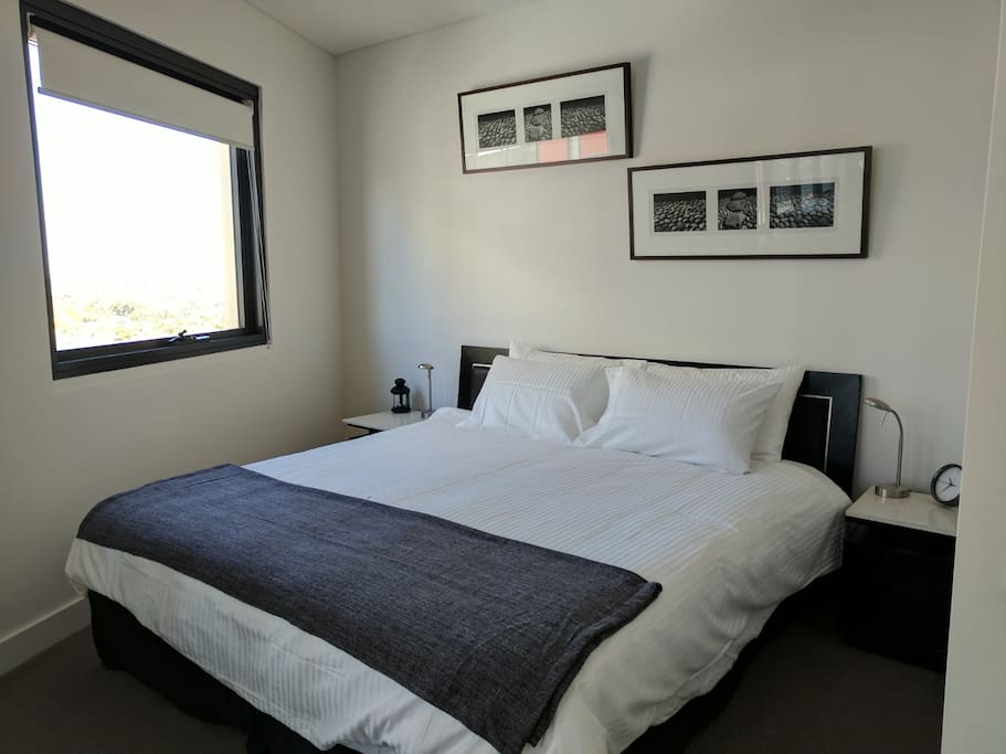 King sized bed with fresh linen awaits
