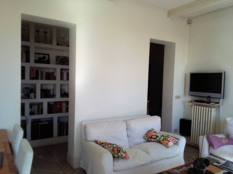 living room with sofas dining table and TV