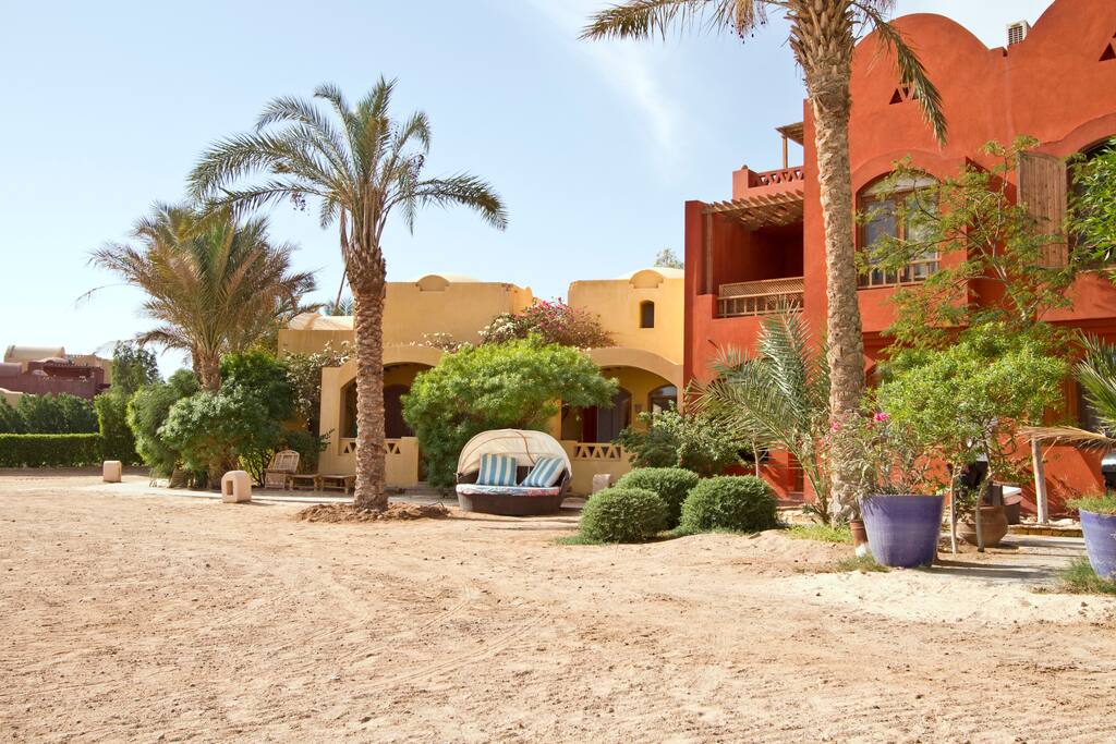 The studio is set on a lagoon beach, with a cosy lounge chair.