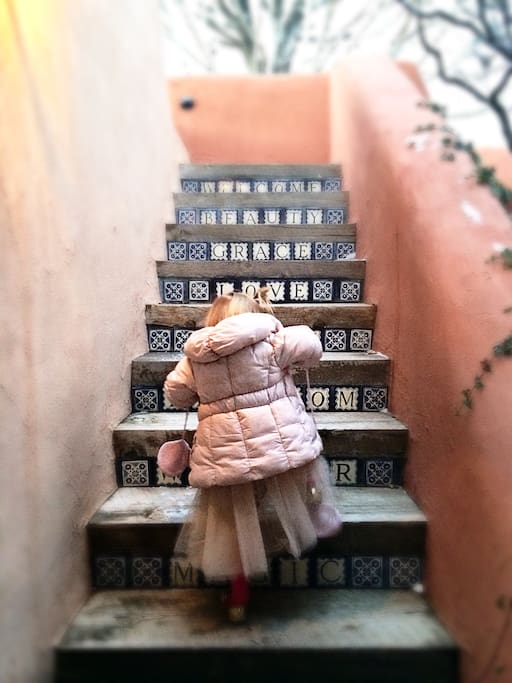 Granddaughter climbing stairs to the roof deck