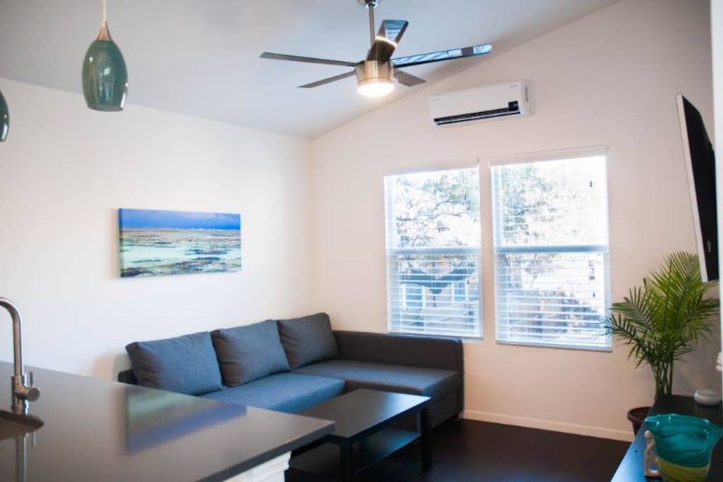 Living room has Ikea couch, providing comfortable seating. Lots of natural light to enjoy throughout and a split unit AC/Heating unit with ceiling fan.