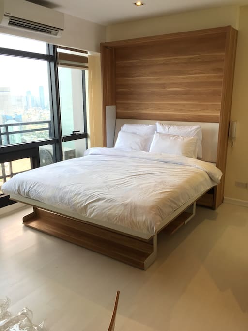 Kingsize wall type bed convertible to a work desk.