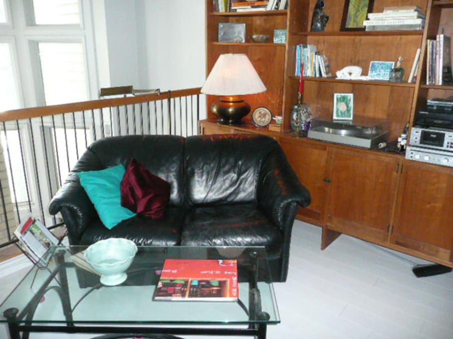 Mid floor den with TV, music room, same floor as mid floor bedroom and bathroom.
