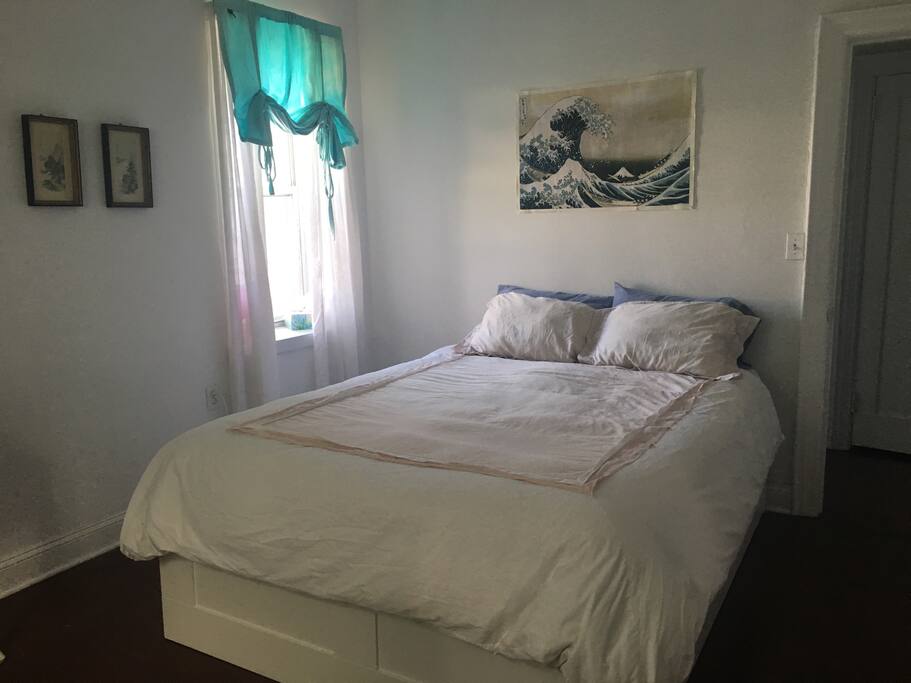 Large bright and airy bedroom with ocean view.