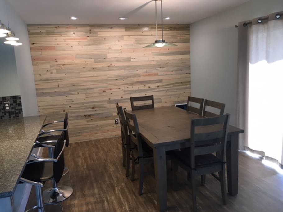 Dining room with plenty of seating for guests and beetle kill accent wall