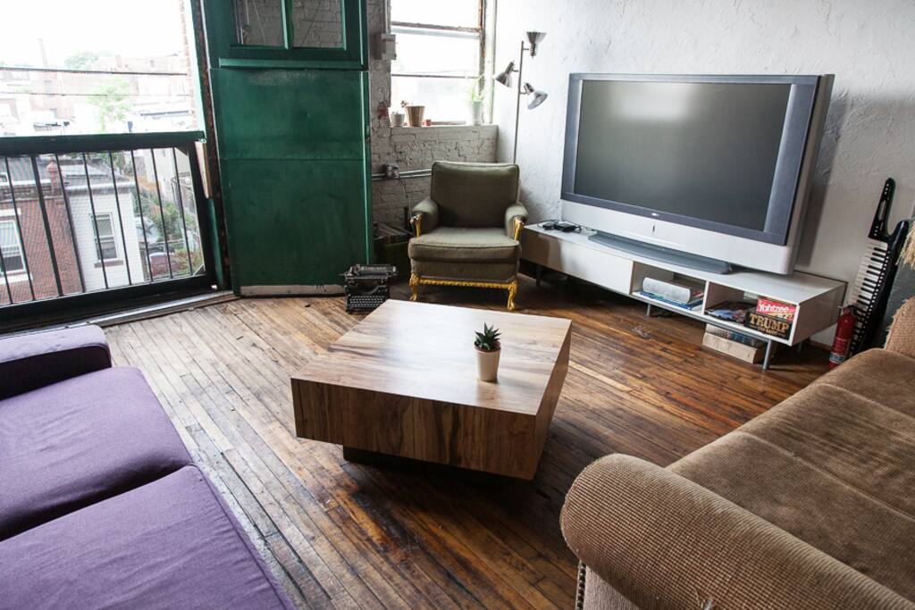Living area with large opening that looks over the city, and big screen TV you can plug your laptop into for larger viewing (if your laptop has an HDMI port)