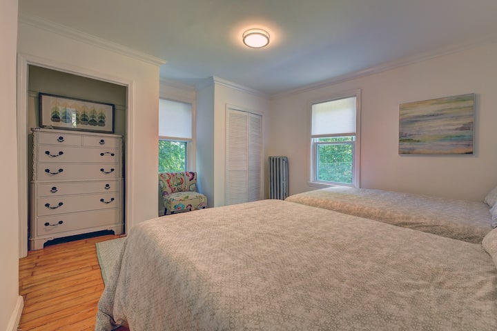 Retreat to our cozy upper-floor bedroom, featuring two comfortable double beds and a convenient chest of drawers, creating a perfect sanctuary for up to 4 guests.