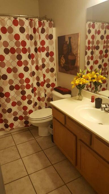 This bathroom has a tub and extra large vanity. Shampoo, soap and towels are included.