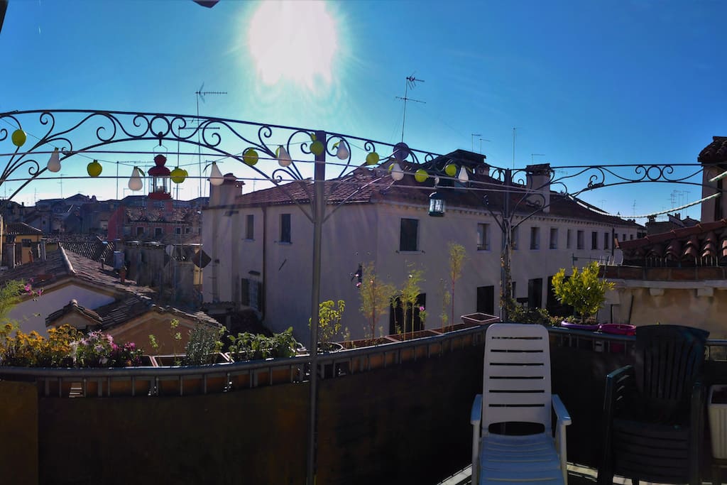 Sunny rooftop terrace with breathtaking view over Venice.