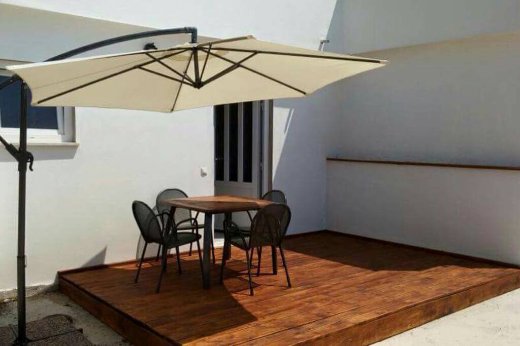 Studio apartment terrace with table and chairs