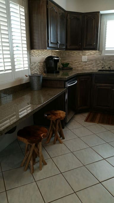 Beautiful granite kitchen countertops above expertly updated rusticly finished cabinets. What we call "Cowboy Contemporary".