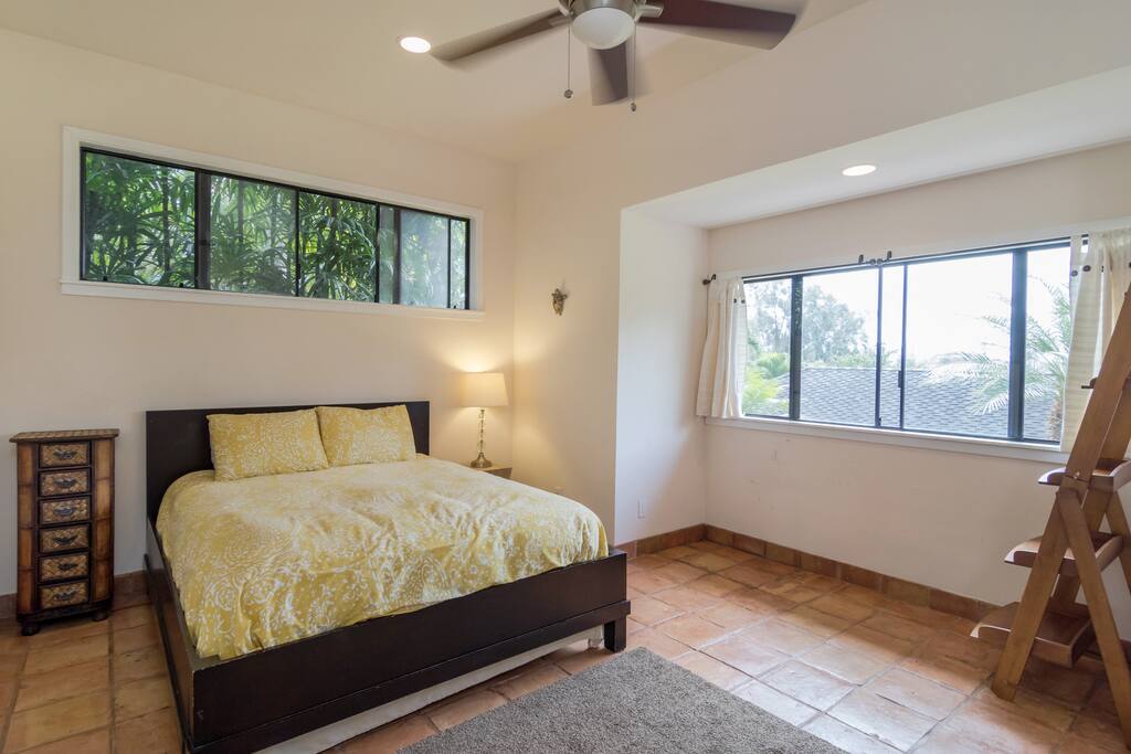 Comfortable and spacious bedroom with high ceilings