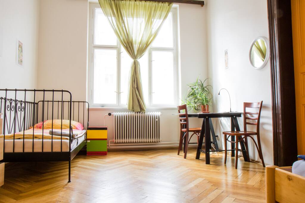 There are three beds in the room with the view to the main street. We provide flip-flops, towels and fresh water :)