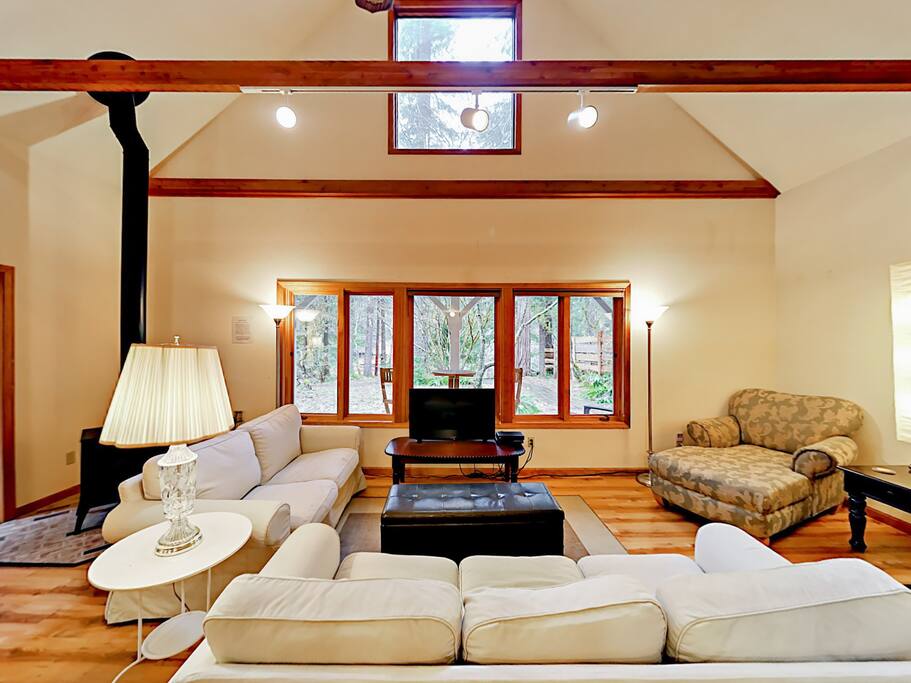 Natural light pours into the grand living space with a gas fireplace anchoring the open room.