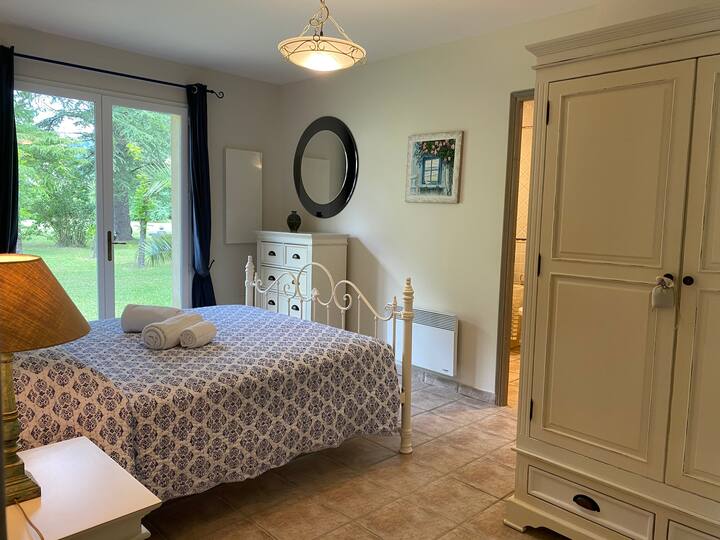 Main bedroom with UK King size bed and en-suite bathroom with bath and shower. There is also a washing machine in the bathroom.