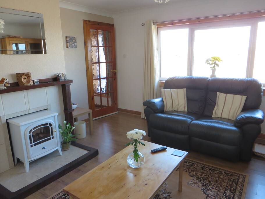 Picture of the lounge looking towards the door and window with view to the street.