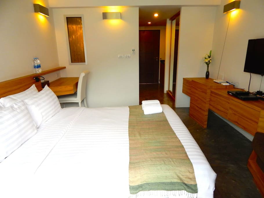 Comfortable queen size bed with extra pillows.